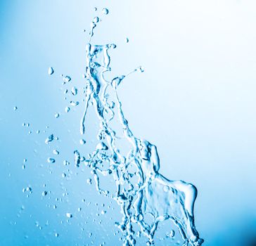 shot of water splashing on blue background