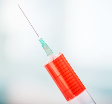 syringe with red drug inside