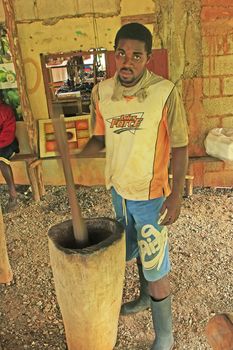 Local man processing cocoa beans in small village factory, Samana peninsula, Dominican Republic