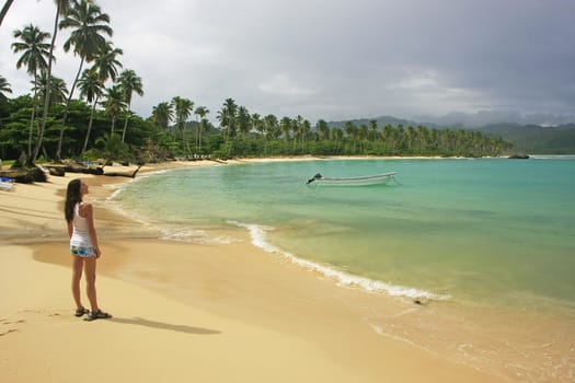 Young woman standing at Rincon beach, Samana peninsula, Dominican Republic