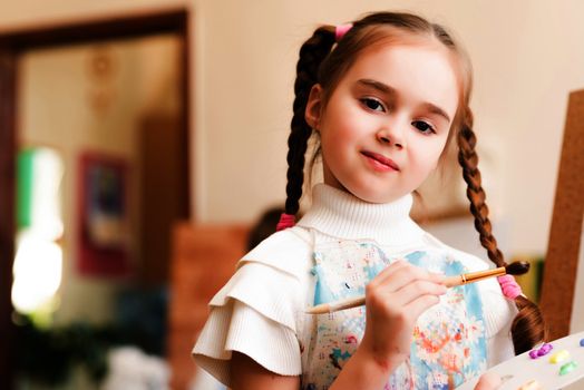 portrait of a girl standing next to his easel, a drawing lesson