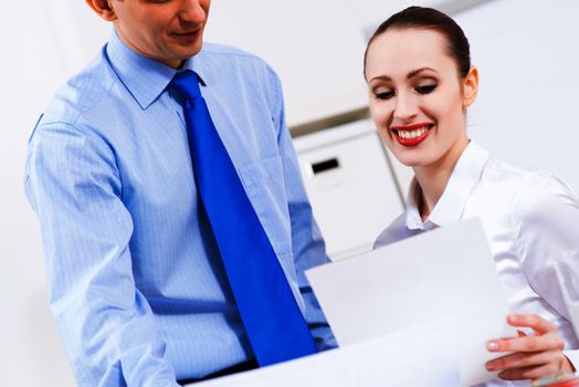 colleagues discuss the reports at a desk in the office, working together in business