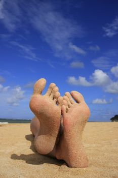 Sandy feet on a tropical beach