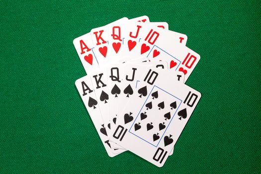 Poker cards with royal flush combination on green cloth