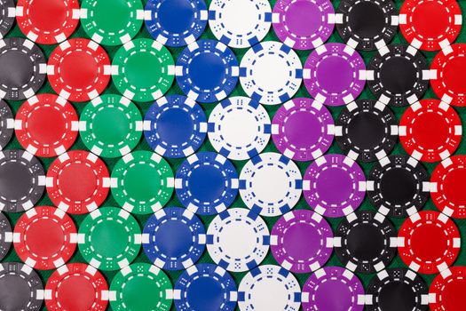 Colorful poker chips closeup on green cloth, backdrop