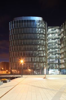 skyscraper  with  glass walls and steel structure at night