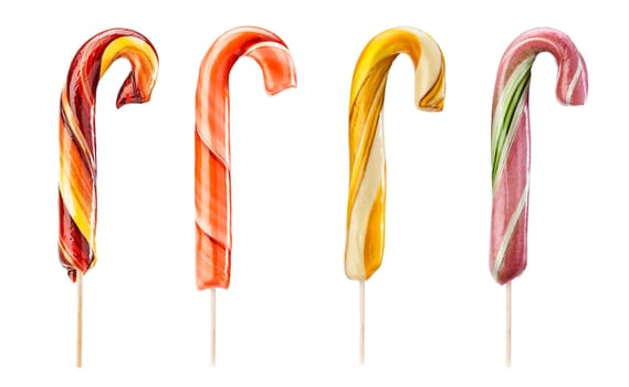Set of twirled caramel candies on sticks, different colors. File includes clipping path