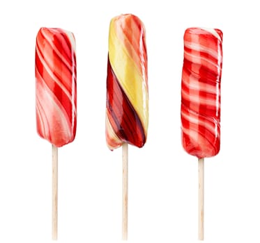 Set of twirled caramel candies on sticks, different colors. File includes clipping path