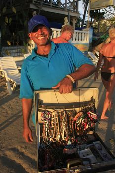 Local man selling jewelry at Boca Chica beach, Dominican Republic