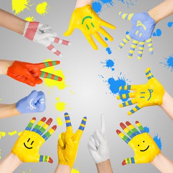 painted children's hands in different colors with smilies