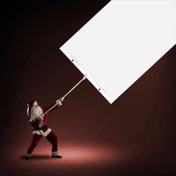 Santa Claus pulls a banner of cloth with a rope, place for text