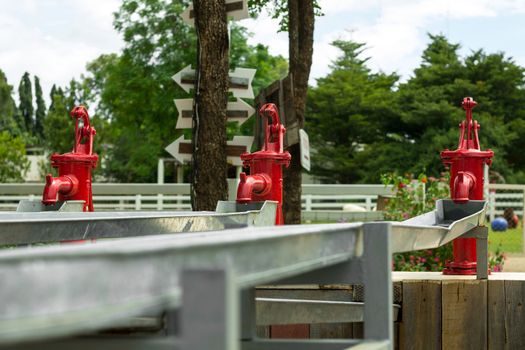 Three red Retro Water Pump outdoor