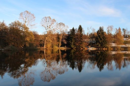 Beautiful lake in autumn with trees reflection.