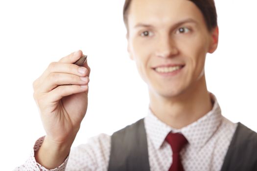 Smiling businessman is writing on a virtual whiteboard. Focus is on the hand and pen