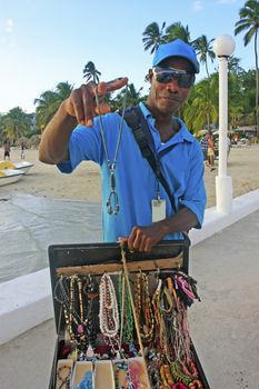 Local man selling jewelry at Boca Chica beach, Dominican Republic