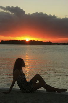 Silhouette of young woman at sunset, Boca Chica bay, Dominican Republic