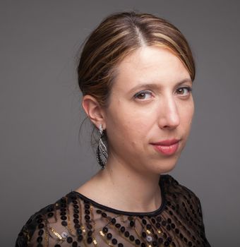 Attractive caucasion girl in her 30s shot in studio isolated on a grey background background