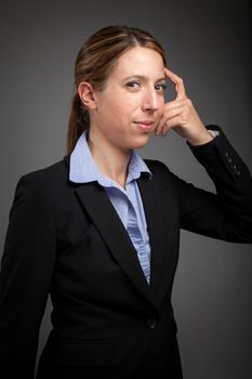 Attractive caucasion business woman in her 30s shot in studio isolated on a white background in her 30s shot in studio isolated on a grey background