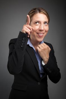 Attractive caucasion business woman in her 30s shot in studio isolated on a white background in her 30s shot in studio isolated on a grey background