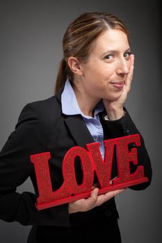 Attractive caucasion business woman in her 30s shot in studio isolated on a white background in her 30s shot in studio isolated on a grey background