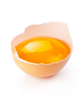 Broken egg with yolk on white background