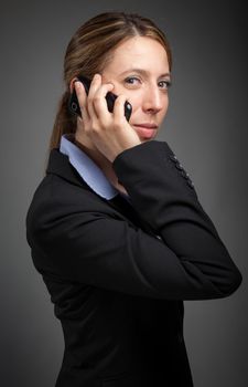 Attractive caucasion business woman in her 30s shot in studio isolated on a white background in her 30s shot in studio isolated on a grey background