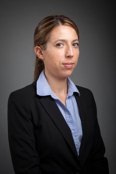 Attractive caucasion business woman in her 30s shot in studio isolated on a white background in her 30s shot in studio isolated on a grey background