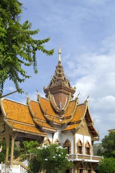 An ornate Thai temple with blue skies