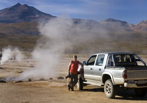 Tourist at the El Tatio Geysers high in the Andes Mountains in the Atacama Desert in northern Chile.