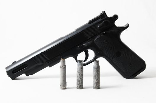 Pistol Gun and Bullets on a White Background