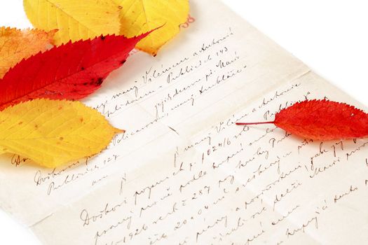 handwritten old letter with color autumn leaves