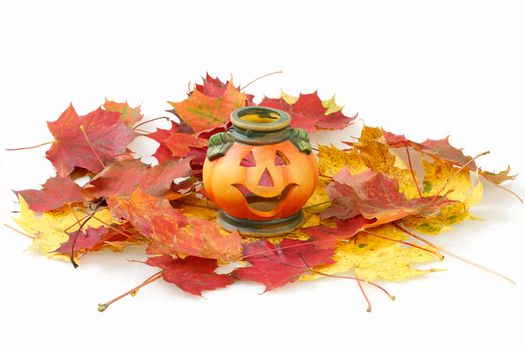 Halloween Pumpkin Lantern with yellow and red autumn leaves