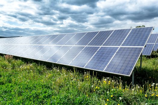 Solar energy panels against dramatic storm sky