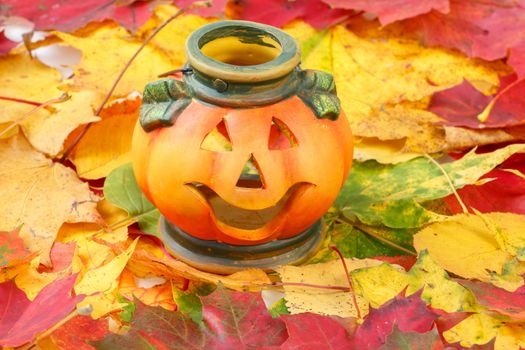 Halloween Pumpkin Lantern with yellow and red autumn leaves