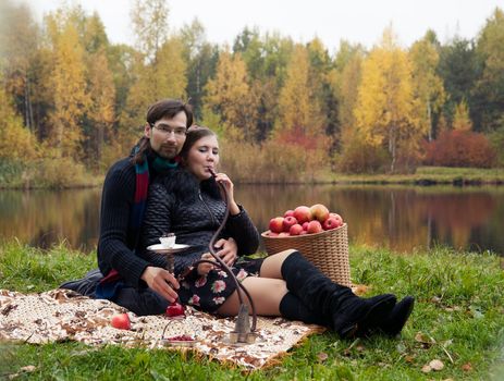 relationship between man and a woman at a picnic with a hookah