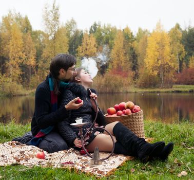 relationship between man and a woman at a picnic with a hookah