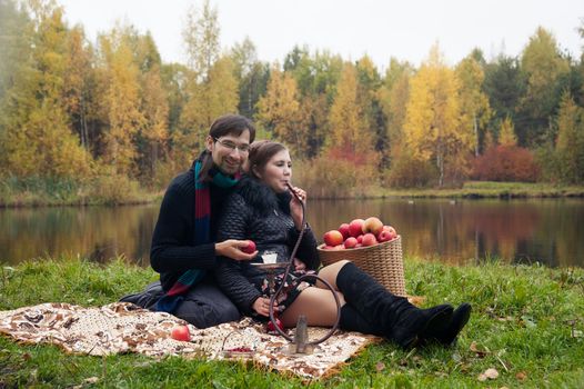 relationship between man and a woman at a picnic with a hookah