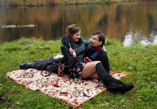 relationship between man and a woman at a picnic with a hookah