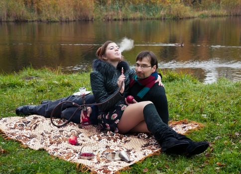 relationship between man and a woman at a picnic with a hookah