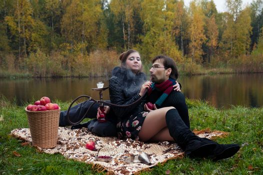 relationship between man and a woman at a picnic with a hookah