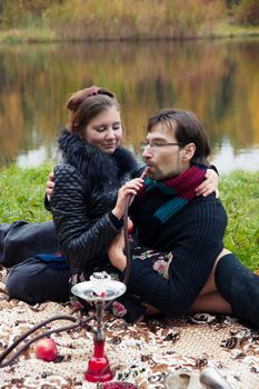 relationship between man and a woman at a picnic with a hookah