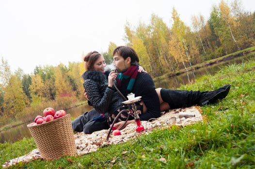 relationship between man and a woman at a picnic with a hookah