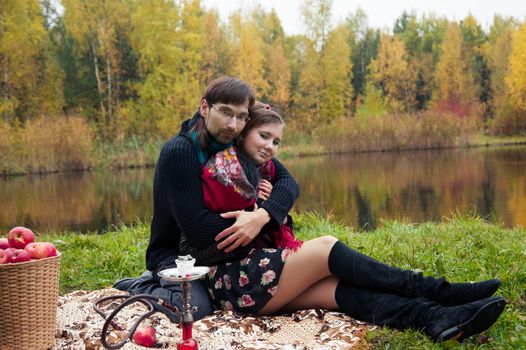 relationship between man and a woman at a picnic with a hookah