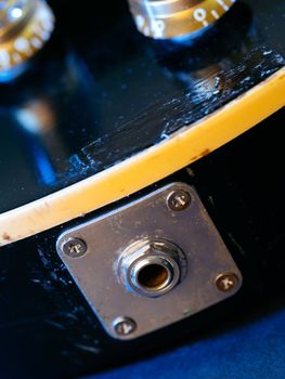 Macro photo of the output jack from an old electric guitar.