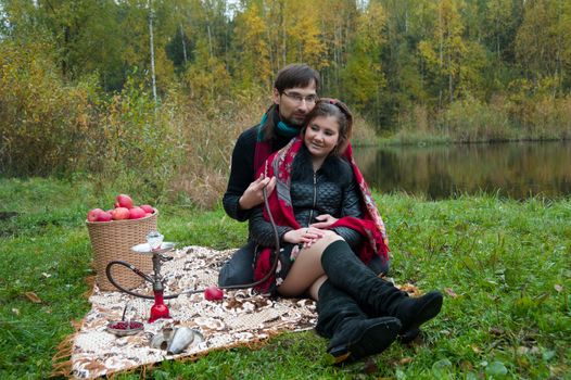 relationship between man and a woman at a picnic with a hookah