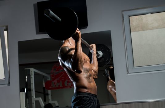 Man Lifting Barbell In Gym