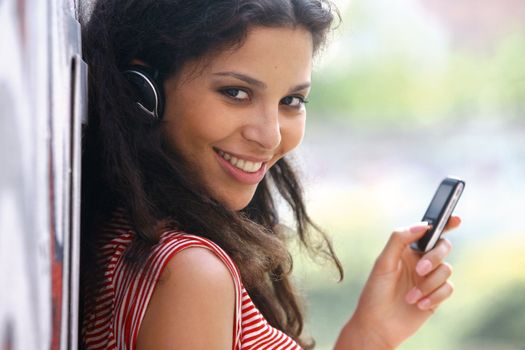 Jolly young woman in headphones listen to music