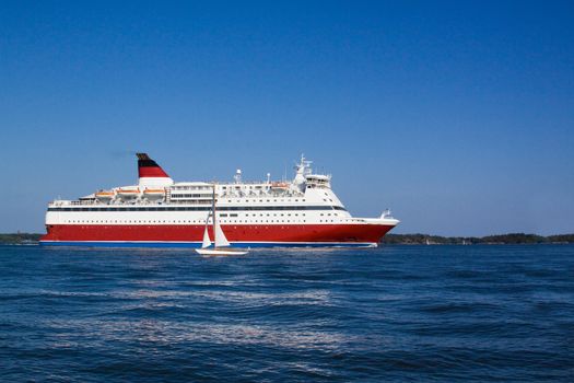 
the passenger cruise liner floats by sea by the island


