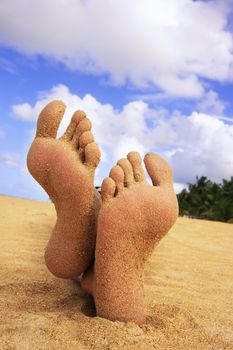Sandy feet on a tropical beach