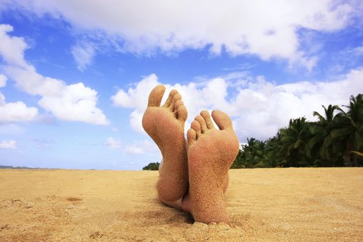 Sandy feet on a tropical beach
